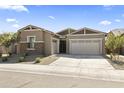 Two-car garage and front entry of a charming tan home at 19151 W Coolidge St, Litchfield Park, AZ 85340