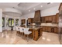 Gourmet kitchen boasts granite countertops and custom wood cabinetry at 2494 E Cloud Dr, Chandler, AZ 85249