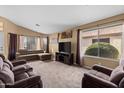 Bright and airy living room with comfortable seating and large TV at 1018 W Juniper Ave, Gilbert, AZ 85233