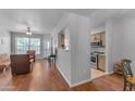 Open living room with wood floors and kitchen access at 14950 W Mountain View Blvd # 1105, Surprise, AZ 85374