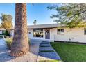 Front entry with walkway and mature palm tree at 8319 E Palm Ln, Scottsdale, AZ 85257