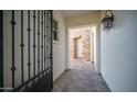 View through an ornate gate to a courtyard with stone walls at 1819 E Palmaire Ave, Phoenix, AZ 85020