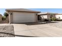 Single story home with a two car garage and desert landscaping at 26634 S New Town Dr, Sun Lakes, AZ 85248