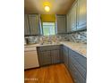 Galley kitchen with gray cabinets and granite counters at 2701 E Allred Ave # 14, Mesa, AZ 85204