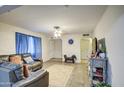 Spacious living room with tiled floors and comfortable leather seating at 8836 N 28Th Dr, Phoenix, AZ 85051