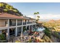 Hillside home with pool, expansive patio, and city views at 4636 E Moonlight Way, Paradise Valley, AZ 85253