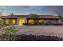 Front view of a ranch-style home with a curved driveway and desert landscaping at 36444 N Stardust Ln, Carefree, AZ 85377