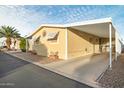 Side view of a yellow single wide mobile home at 11596 W Sierra Dawn Blvd # 40, Surprise, AZ 85378