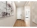 Bright entryway with hardwood floors and large artwork at 18252 W Cielo Grande Ave, Surprise, AZ 85387