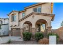 Two-story house with brown garage door and brick accents at 8605 E Posada Ave, Mesa, AZ 85212