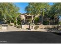 Luxury home exterior with a circular driveway at 19481 N 98Th Pl, Scottsdale, AZ 85255