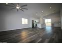 Open concept living room with kitchen and wood floors at 12601 W Diaz Dr, Arizona City, AZ 85123