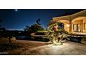 Night view of a luxurious pool and patio area at 4836 E White Gates Dr, Phoenix, AZ 85018