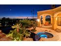 Luxury backyard oasis with a pool and spa at sunset at 4836 E White Gates Dr, Phoenix, AZ 85018