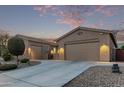 Single story home with a two car garage and desert landscaping at 23680 N 168Th Ln, Surprise, AZ 85387