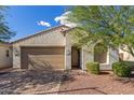 Single-story home with a two-car garage and landscaped front yard at 21950 N 100Th Ave, Peoria, AZ 85383