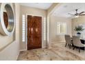 Elegant entryway with rich wood door and tile flooring at 28847 N Royce Rd, San Tan Valley, AZ 85144