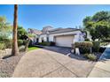 Single-story home with attached garage and landscaped front yard at 7272 E Gainey Ranch Rd # 13, Scottsdale, AZ 85258