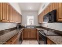 Small kitchen with granite countertops and wood cabinets at 1116 E Belmont Ave, Phoenix, AZ 85020