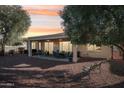 Covered patio with seating and desert landscaping at 13518 W Sola Dr, Sun City West, AZ 85375