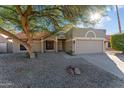 House exterior showcasing a two car garage and desert landscaping at 7631 W Mcrae Way, Glendale, AZ 85308