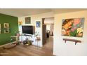 Living room features hardwood floors and a view into the kitchen at 520 N Santa Barbara St, Mesa, AZ 85201