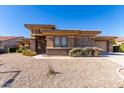 Single-story home with two-car garage and desert landscaping at 2634 N 141St Ln, Goodyear, AZ 85395