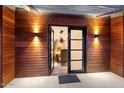 Double front doors with wood paneling and modern lighting at 4632 E Desert Park Pl, Paradise Valley, AZ 85253