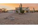 Two-story home with desert landscaping at sunset at 10802 S Santa Margarita Dr, Goodyear, AZ 85338