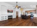 Open living room and kitchen with hardwood floors and a fireplace at 17006 N 44Th Pl, Phoenix, AZ 85032