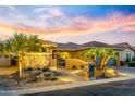 Single story home features a beautiful stone accent wall and mature landscaping at 16495 W Almeria Rd, Goodyear, AZ 85395