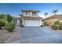Two-story house with attached garage and desert landscaping at 218 E Sunburst Ln, Tempe, AZ 85284