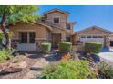 Two-story house with stone accents, landscaping, and a three-car garage at 12473 W Montgomery Rd, Peoria, AZ 85383