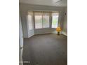 Bright bedroom with bay window and carpet at 20407 N 107Th Dr, Sun City, AZ 85373