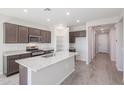 Modern kitchen with island, stainless steel appliances, and granite countertops at 3431 S 177Th Ave, Goodyear, AZ 85338