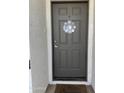 Gray front door with metal flower decoration at 8467 W Tinajas Dr, Arizona City, AZ 85123