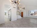 Open living room and kitchen with gray floors and modern chandelier at 1207 N Velero St, Chandler, AZ 85225