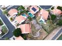 Aerial view of house and surrounding neighborhood with pool at 5702 W Windrose Dr, Glendale, AZ 85304