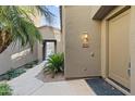 Inviting entryway with a private path and mature landscaping at 19550 N Grayhawk Dr # 2018, Scottsdale, AZ 85255