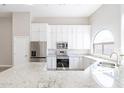 Modern kitchen with white cabinets, granite countertops, and stainless steel appliances at 8753 E Greenview Dr, Gold Canyon, AZ 85118