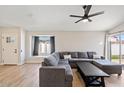 Spacious living room with large sectional sofa and wood flooring at 6617 E Northridge St, Mesa, AZ 85215