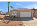 Single story home with attached garage and desert landscaping at 6617 E Northridge St, Mesa, AZ 85215