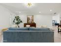 View of living room from another angle, showcasing the blue sofa and decor at 8728 E Via De Viva --, Scottsdale, AZ 85258