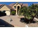 Two-story house with a tan exterior, two-car garage, and desert landscaping at 2474 E Westchester Dr, Chandler, AZ 85249