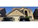 Two-story house with a tan exterior, two-car garage, and desert landscaping at 2474 E Westchester Dr, Chandler, AZ 85249