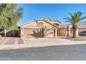 Tan two-story house with a two-car garage and desert landscaping at 12430 W Virginia Ave, Avondale, AZ 85392