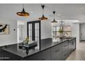 Contemporary kitchen with large island and pendant lighting at 3800 E Lincoln Dr # 42, Phoenix, AZ 85018