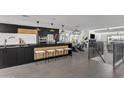 Modern kitchen with black cabinetry, a large island, and stainless steel appliances at 3800 E Lincoln Dr # 42, Phoenix, AZ 85018