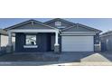 New construction home with gray exterior, white garage door, and stone accents at 22865 E Roundup Way, Queen Creek, AZ 85142