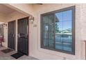 Condo building entryway with a secure door and a window offering a view at 455 S Delaware Dr # 120, Apache Junction, AZ 85120